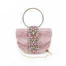 Pink textured handbag with decorative chain and gemstones on a white background, featuring 'Obroi' logo.