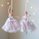 Two decorative ballerina figurines in pink and white dresses against a neutral background, Obroi