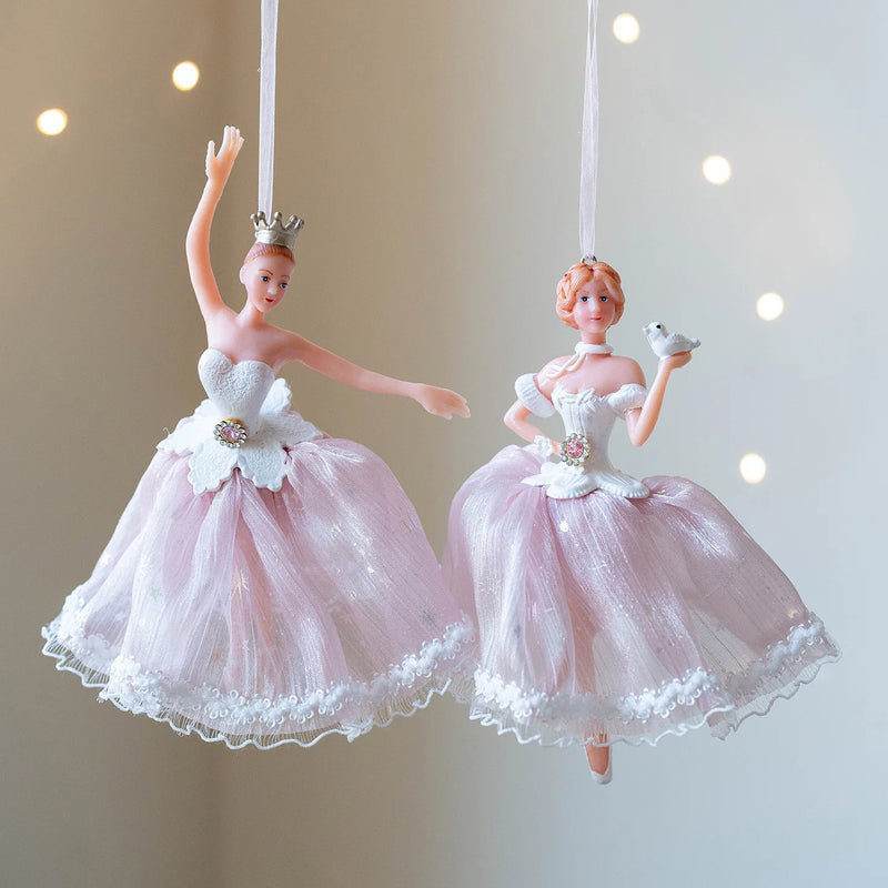 Two decorative ballerina figurines in pink and white dresses against a neutral background, Obroi