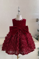 Red floral dress on a mannequin with a Christmas tree in the background, Obroi