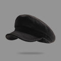 Black flat cap on a gray background, Obroi