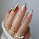 Hand with gold and pink nail design wearing gold rings on a neutral background, Obroi