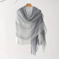 Gray shawl with fringe on a wooden hanger against a white background, Obroi