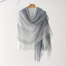 Gray shawl with fringe on a wooden hanger against a white background, Obroi