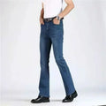 Person wearing blue jeans and black shoes on a white background, Obroi