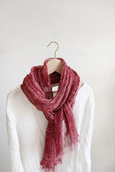 Pink scarf draped over a mannequin wearing a white shirt on a plain background, Obroi