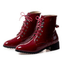 Shiny red combat boots with pink laces on a white background, Obroi