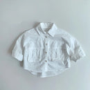 White shirt with rolled-up sleeves on a light gray background, Obroi