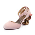 Pink high-heeled shoe with decorative heel and floral details on a white background, Obroi