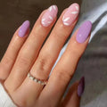 Hand with pastel pink and purple nail polish on a neutral background, Obroi