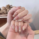 Hand with decorative nail art on a neutral background, Obroi