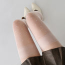 Obroi Beige tights with subtle pattern worn by a person on a plain background