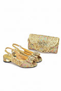 Pair of embellished shoes with a matching handbag on a white background, Obroi
