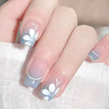 Nails with white floral design on a light background, Obroi