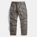 A pair of dark gray cargo pants with multiple utility pockets, laid flat against a light gray background, Obroi