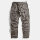 A pair of dark gray cargo pants with multiple utility pockets, laid flat against a light gray background, Obroi
