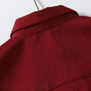 Obroi Close-up of a red textured garment on a white background