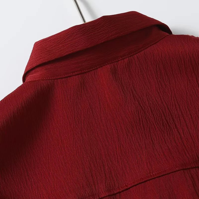 Obroi Close-up of a red textured garment on a white background