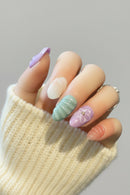 Hand with pastel nail art on a neutral background, Obroi