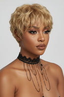 Woman with styled blonde hair and sparkly makeup on a plain background, Obroi