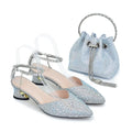Silver embellished shoes and matching handbag on a white background, Obroi
