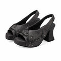 Black suede high-heeled shoes with star embellishments on a white background, Obroi
