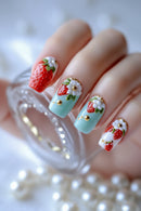 Nails with strawberry and flower design on a light blue background, Obroi