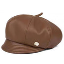 A brown faux-leather newsboy cap with a small gold logo badge on the side, displayed on a clean white background, Obroi