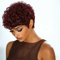 Woman with burgundy curly hair wearing a brown top on a white background, Obroi
