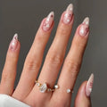 Hand with decorative nails and a ring on a neutral background, Obroi