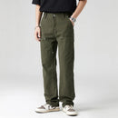 Person wearing olive green pants on a white background, Obroi