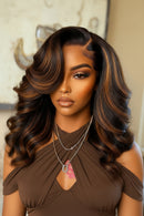 Woman with styled hair and jewelry in a blurred indoor setting, Obroi