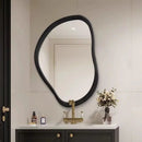 Bathroom vanity with a black mirror, gold faucet, and decorative items, Obroi