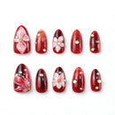 Set of red nail art designs with floral and pearl details on a white background, Obroi