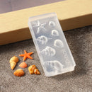 A clear silicone mold with embossed seashell and starfish designs, placed on a sandy surface next to small orange and beige seashells. The mold has vertical branding text that reads '3D-Craft', Obroi