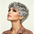 Woman with styled silver hair against a plain background, Obroi