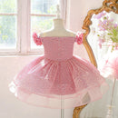 Pink sparkly dress on a mannequin in a room with a window and decorative mirror, Obroi