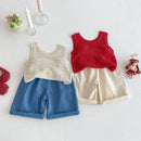 Two children's outfits with knitted tops and shorts on a light background, Obroi