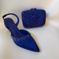 Blue studded high-heeled shoes and matching clutch on a white background, Obroi
