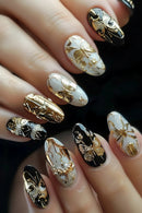 Nails with gold and black decorative designs on a dark background, Obroi