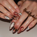 Close-up of hands with decorative nail art on a neutral background, Obroi