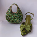 Green jeweled handbag and shoe on a light gray background, Obroi