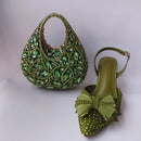 Green jeweled handbag and shoe on a light gray background, Obroi