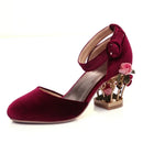 Maroon high-heeled shoe with floral design on a white background, Obroi