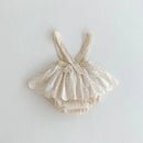 Beige baby romper with lace details on a light gray background, Obroi
