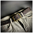 Brown leather belt with gold buckle on a pair of jeans against a blurred background, Obroi