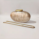 Oval-shaped handbag with a gold handle on a light gray background, Obroi