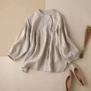 Beige blouse with puffed sleeves on a beige background, accompanied by pink shoes and dried plants, Obroi