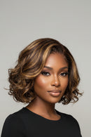Woman with styled hair against a neutral background, Obroi