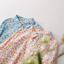 Two floral shirts, one blue and one multicolor, on a light gray background, Obroi